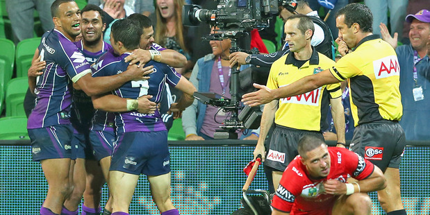 Young Tonumaipea of the Storm is congratulated by teammates after scoring against the Dragons. Photo / Getty Images