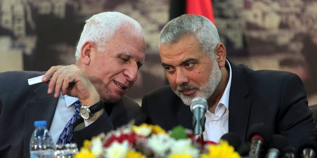 Senior Fatah official Azzam al-Ahmad (left) and Gaza's Hamas Prime Minister Ismail Haniyeh at yesterday's announcement. Photo / AP