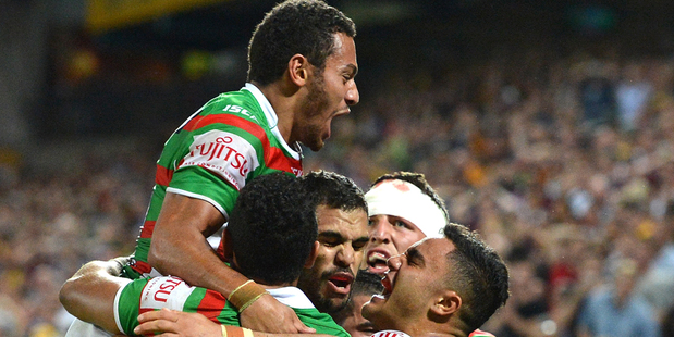 Greg Inglis and his teammates celebrate the final siren in their 28-26 win over the Broncos in Brisbane. Photo / Getty Images