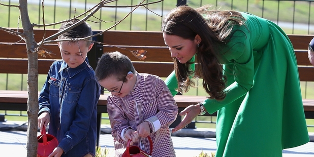 Twins Oliver and Sebastian Lye helped Kate water in the newly-planted English oak tree. Photo / Getty Images