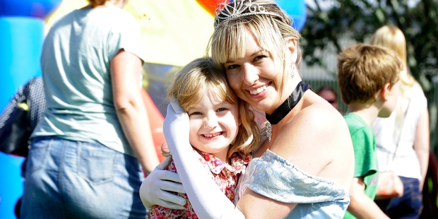 Charlotte Cantlon, 4, jumped at the chance to have her photo taken with princess Kristen Andrews at Easter in the Park. Photo/George Novak