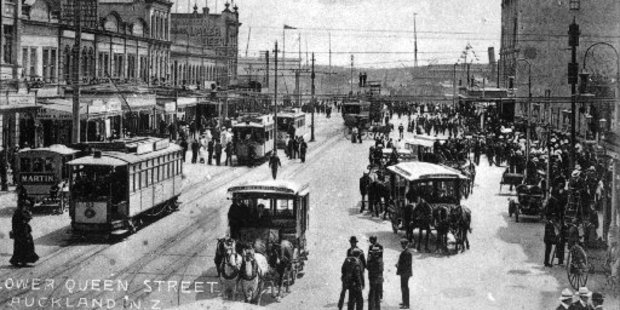 A 1907 traffic medley of electric trams, horse drawn buses and a solitary motor car (parked beside the righthand curb) share Lower Queen St together. File photo / NZ Herald Archive