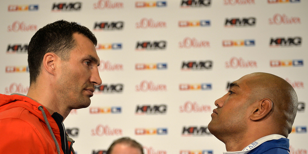Boxing champion Wladimir Klitschko of Ukraine, left, stares at challenger Alex Leapai from Australia-Samoa during a press conference ahead of their heavyweight bout. Photo / AP