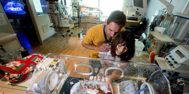 Steven and Lucy Nicoll with their son Joshua, one of triplets born after 25 weeks in the womb. Photo / Dean Purcell