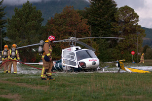 Emergency services at the scene near Taupo hospital yesterday after a Bay Trust rescue helicopter crashed. Two people received minor injuries. JESSICA KATE WILLIAMSON