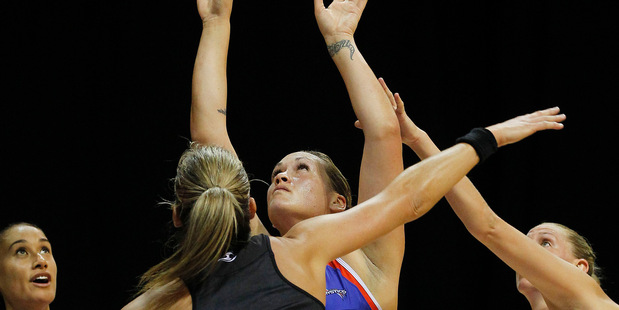 Mystics shooter Cathrine Latu goes for goal while Magic defenders Leana de Bruin, left, and Casey Kopua attempt to put her off during their ANZ Championship netball match in Hamilton last night. Photo / Christine Cornege