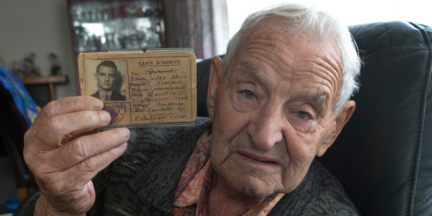 Former Wellington bomber gunner Pat Hickton with the French passport that aided his escape from occupied France. Photo / Mark Mitchell