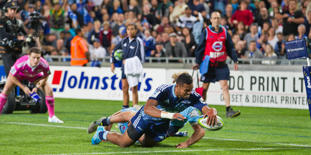 Blues Lolagi Visinia scores during Blues Investec Super Rugby game against the Waratahs at Eden Park on Friday night in front of a great home crowd. Photo / Greg Bowker.