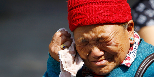 Mother of Nepalese mountaineer Ang Kaji Sherpa, killed in an avalanche on Mount Everest, cries while she waits for his body. Photo / AP