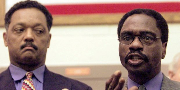 The Reverend Jesse Jackson, left, listens as Rubin "Hurricane" Carter, the former middleweight boxer, speaks during a news conference in 2000. Photo / AP