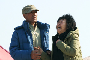 A relative of a passenger aboard the sunken ferry Sewol shouts the name of her missing family member as she waits for their return at a port in Jindo, South Korea. Photo / AP