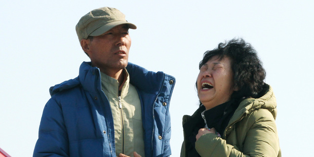 A relative of a passenger aboard the sunken ferry Sewol shouts the name of her missing family member as she waits for their return at a port in Jindo, South Korea. Photo / AP