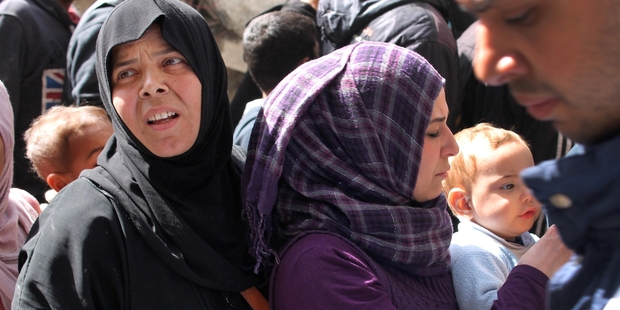 Residents of the besieged Palestinian camp of Yarmouk in Damascus queue in February for UN aid. Photo / AP