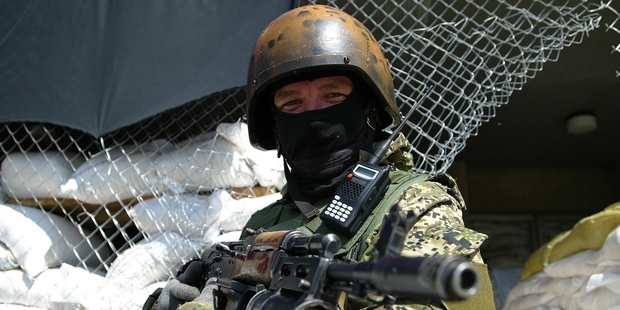 An armed pro-Russian militant guards barricades in front of city hall in Slaviansk, eastern Ukraine. Photo / AP
