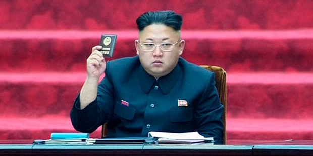 North Korean leader Kim Jong Un holds up parliament membership certificate during the Supreme People's Assembly in Pyongyang. Photo / AP