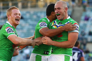 Joel Edwards, Bill Tupou, and Terry Campese embrace after winning the round seven NRL match between the Canberra Raiders and the Melbourne Storm. Photo / Getty Images