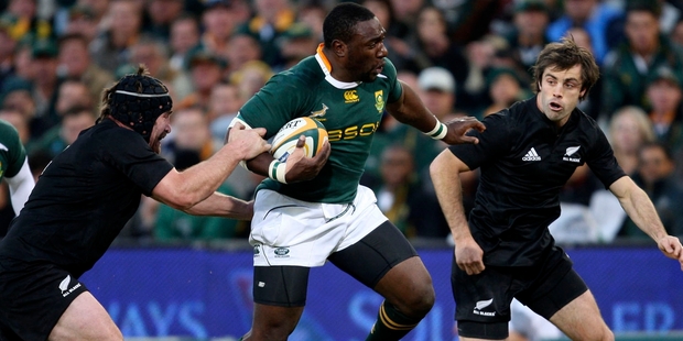 All Blacks Andrew Hore, left, and Conrad Smith, right, tackle South Africa's Tendai Mtawarira in 2009. Photo / AP