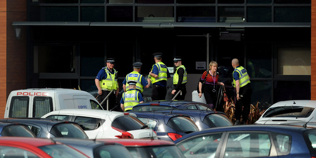 Police stand outside Corpus Christi Catholic College. Photo / AP