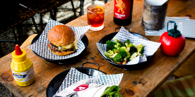 Pork burger and a beef burger in a lettuce leaf bun with broccoli from new burger restaurant Burger Burger. Picture / Babiche Martens