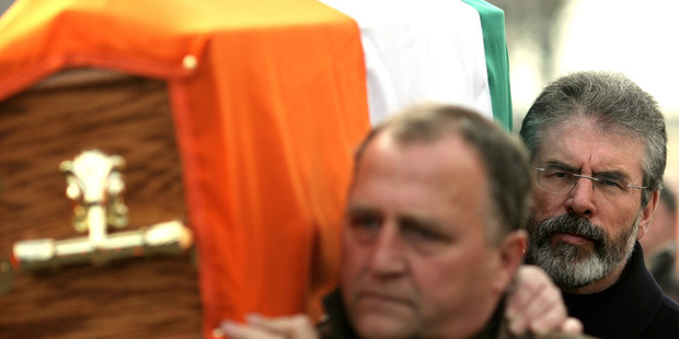2008 file photo of Sinn Fein President Gerry Adams, right, carrying the coffin of senior IRA commander Brendan Hughes, in west Belfast. Photo / AP