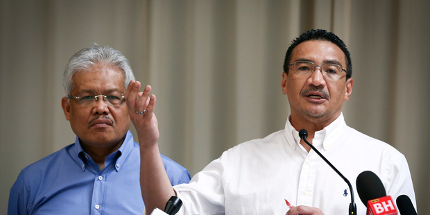 April 19 file photo, Malaysian Deputy Minister of Foreign Affairs Hamzah Zainudin, left, listening to acting Transport Minister Hishammuddin Hussein at a briefing. Photo / AP