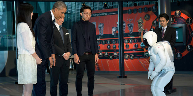 Asimo meets Barack Obama. Honda says the robot's technology can be applied to cars. Picture /AP