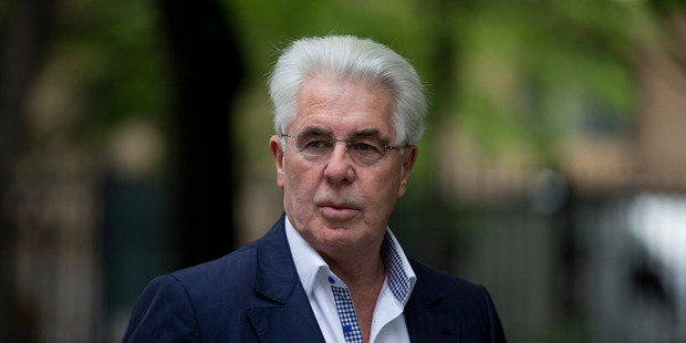 British public relations guru Max Clifford stops to pose for members of the media as he arrives for his trial at Southwark Crown Court in London. Photo / AP