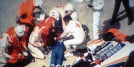 Rescue crew members give first aid to unconscious formula one driver Ayrton Senna, lying mortally injured, beside his wrecked car after the crash at the Italian Imola track. Photo / AP