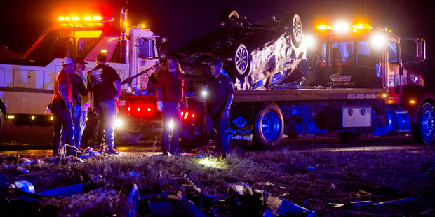 Residents walk past damage in Mayflower, Ark., after a tornado struck the town. Photo / AP