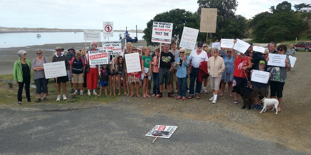MAKING A STATEMENT: Mangawhai residents protest over a proposal to sell 'surplus' Mangawhai Heads land to help settle Kaipara District Council debt.PHOTO/MRRA