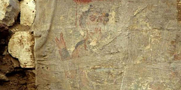 An image buried deep within crypt shows a young man with curly hair, who appears to be giving a blessing . Photo / University of Barcelona