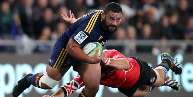 Ma'afu Fia of the Highlanders bursts through the Lions defence last night. Photo / Getty Images