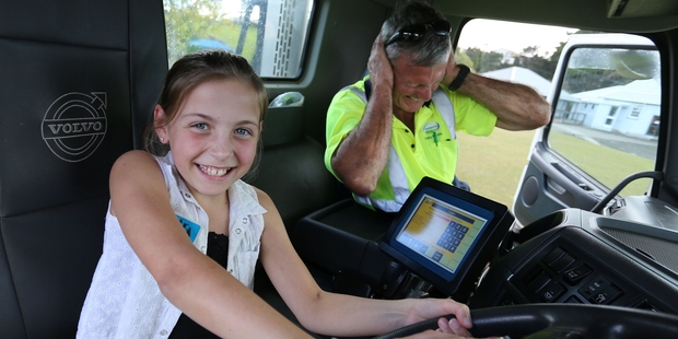 Charlotte Thurgood lets Fonterra tanker driver Mike Griffin know how loud the horn is at the school. Photo / John Stone