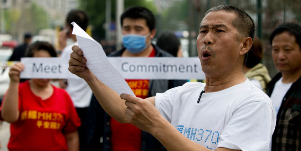 A relative of Chinese passengers onboard the Malaysia Airlines MH370 speaks to media. Photo / AP