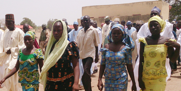 Four female students who were abducted by gunmen are reunited with their families in Chibok, Nigeria. Photo / AP