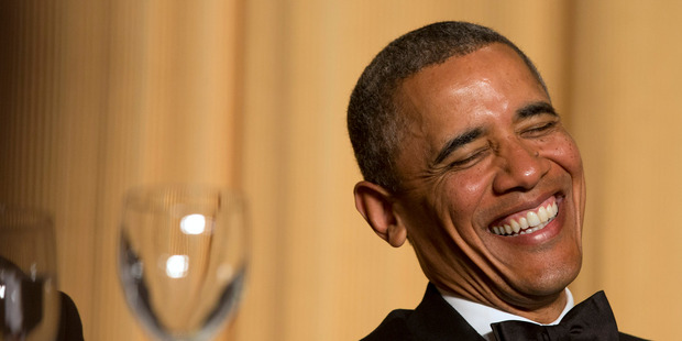 President Barack Obama laughs as actor and comedian Joel McHale speaks during the White House Correspondents' Association (WHCA) Dinner. Photo / AP