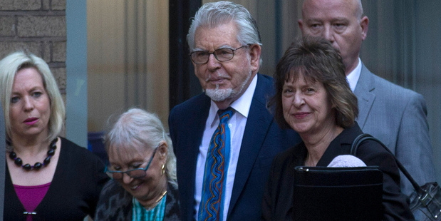 Veteran entertainer Rolf Harris, third right, arrives with his wife Alwen Hughes, second left, and daughter Bindi, first left, at Southwark Crown Court in London. Photo / AP