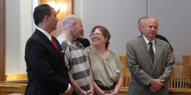 Jeremy Moody, left, talks to his wife, Christine Moody, right, while standing with their lawyers. Photo / AP