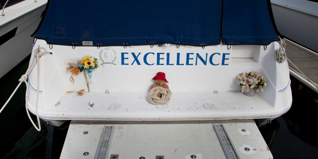 A child's teddy bear and flowers were placed at the back of the family boat.