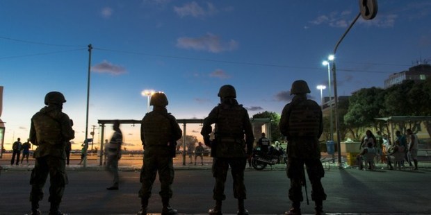Brazilian troops stand guard after being deployed to maintain security after police declared a strike in Salvador, northeast of Brazil. Photo / AP