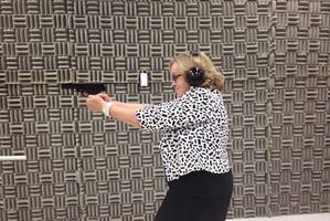 Judith Collins firing a gun in a photo uploaded to her Facebook page.