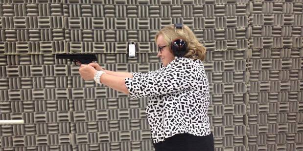 Judith Collins firing a gun in a photo uploaded to her Facebook page.