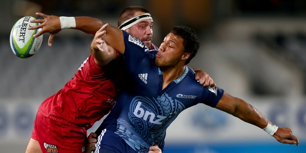 Blues back George Moala offloads against the Reds at eden park on friday night. Photo / Getty Images