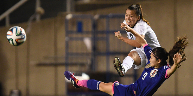 Ali Riley of New Zealand passes the ball while Nahomi Kawasumi of Japan tackles her. Photo / Getty Images