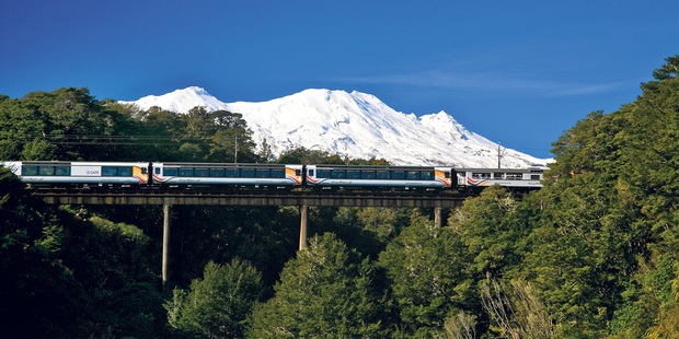 Snow-capped mountains form the perfect backdrop as the Northern Explorer travels near National Park.