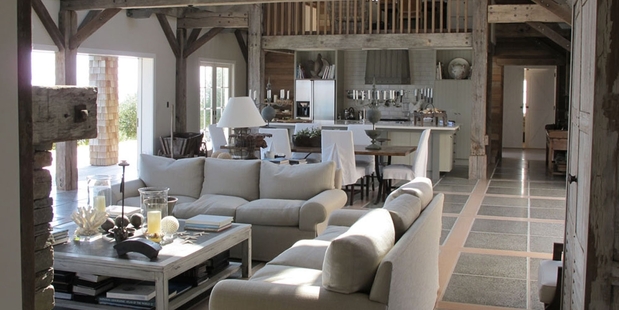 Designed by Sumich Chaplin, the 'Barn House' has recycled beams from old railway bridges which are left exposed in the living room.