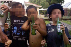 The mother of two of the children holding beer says the photo was posed without her knowledge at a friend's place about three years ago.