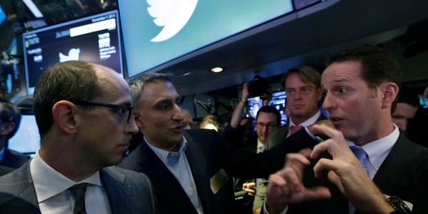 Twitter CEO Dick Costolo, left, and Mike Gupta, center, CFO of Twitter, talk with specialist Glenn Carell during Twitter's IPO, on the floor of the New York Stock Exchange. Photo / AP