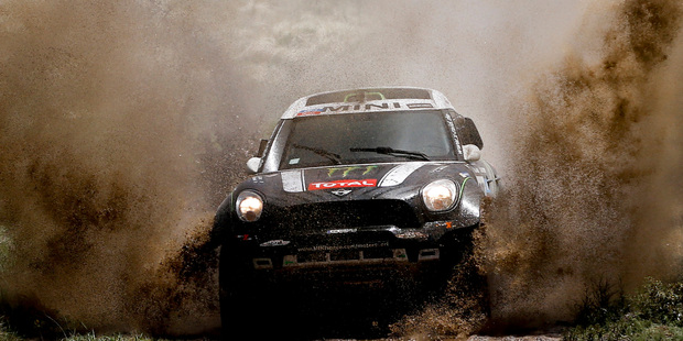 Mini driver Stephane Peterhansel and co-pilot Jean Paul Cottret, both of France, race through a creek during the first stage of the Dakar Rally. Photo / AP
