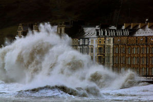 Waves crash against the Aberystwyth coastline, in Wales, as strong winds and high tides continue to blow in from the west. Photo / AP